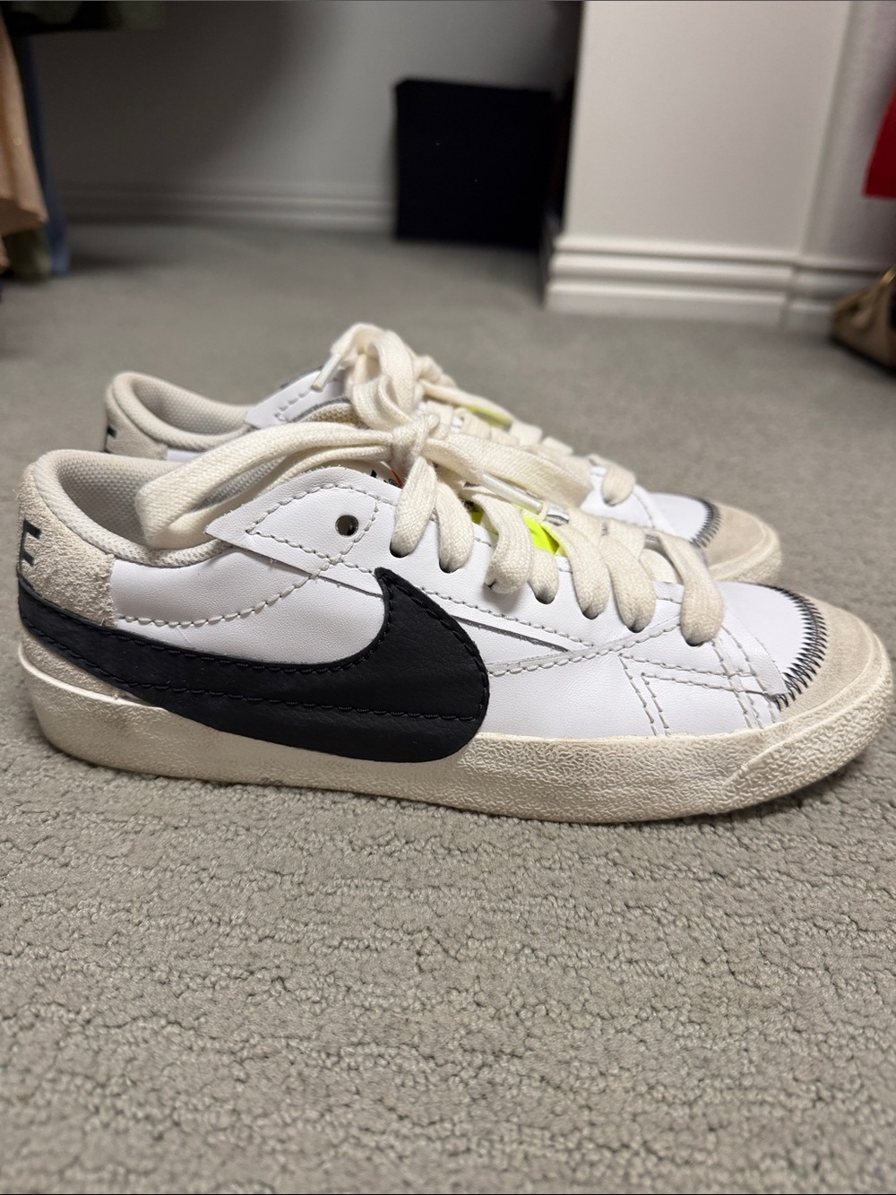 Nike Kids White Sneakers with Black Swoosh and Subtle Neon Accent